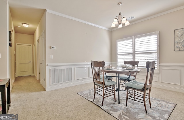 dining area featuring light carpet, ornamental molding, and an inviting chandelier