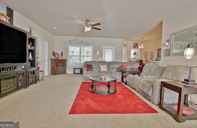 living room with ceiling fan with notable chandelier and light carpet