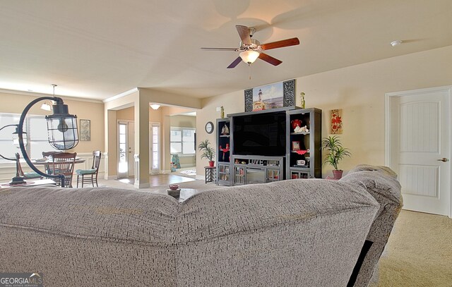 carpeted living room with ceiling fan