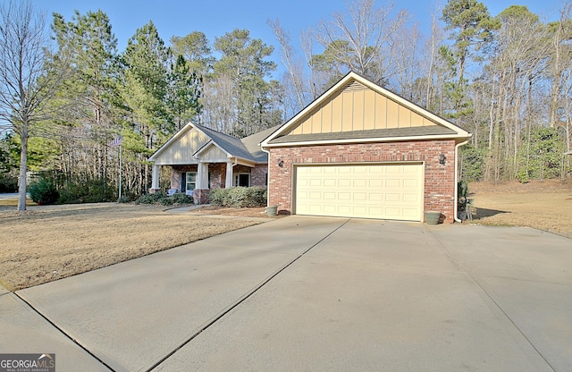 craftsman inspired home with board and batten siding, concrete driveway, brick siding, and a garage