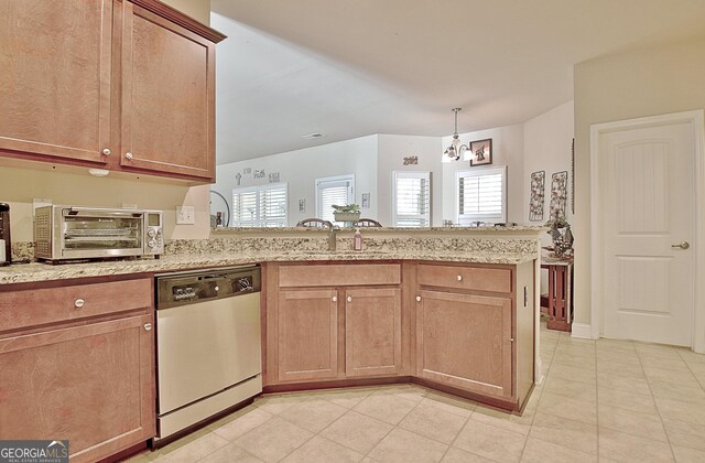 kitchen with sink, light stone counters, hanging light fixtures, appliances with stainless steel finishes, and decorative backsplash