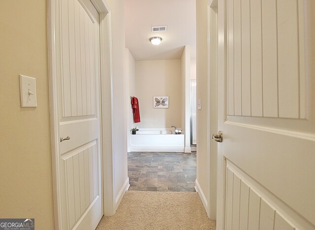 carpeted bedroom featuring multiple windows and a tray ceiling