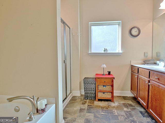 bathroom featuring independent shower and bath and vanity