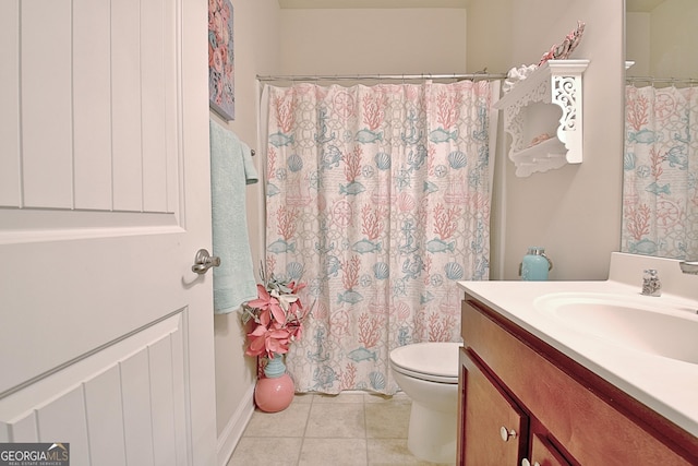 bathroom featuring tile patterned flooring, vanity, and toilet