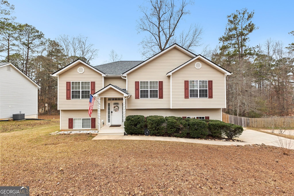 bi-level home featuring a front yard and central AC