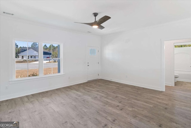 unfurnished room with ceiling fan, wood-type flooring, and ornamental molding