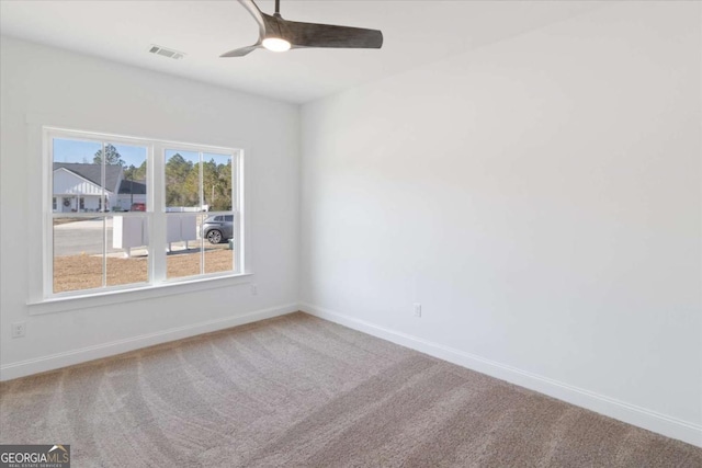 carpeted empty room featuring ceiling fan