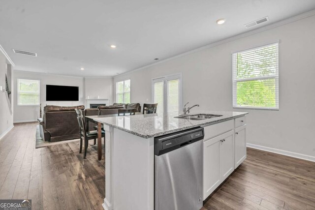 kitchen with dishwasher, white cabinets, dark hardwood / wood-style floors, an island with sink, and light stone counters