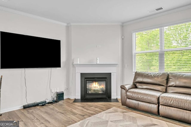 living room with crown molding and light hardwood / wood-style flooring