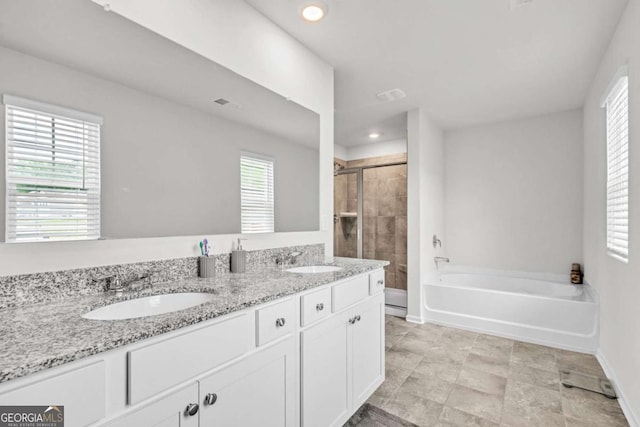 bathroom with vanity and separate shower and tub