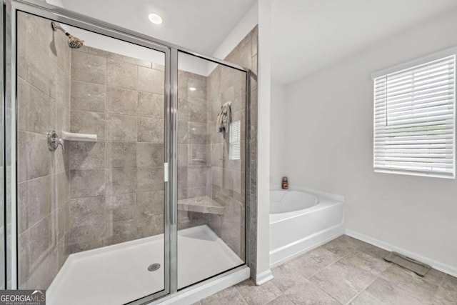 bathroom featuring independent shower and bath