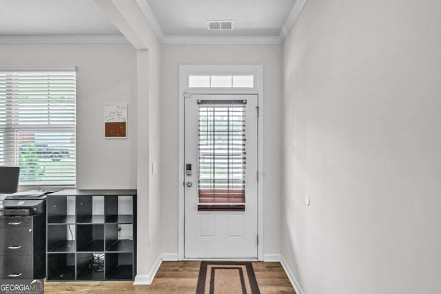 doorway to outside featuring hardwood / wood-style floors and ornamental molding