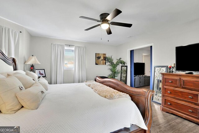 living room featuring ceiling fan and wood-type flooring