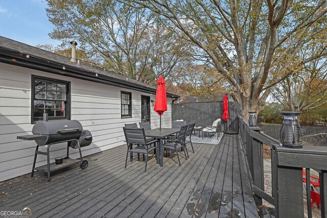 view of patio / terrace with a fire pit and a deck