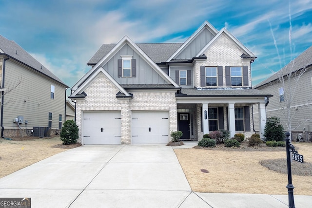 craftsman-style house featuring a porch, central AC unit, and a garage