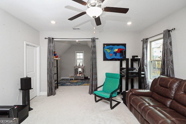 living room featuring light colored carpet, ceiling fan, and lofted ceiling