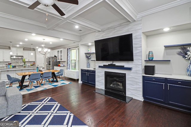 living room with coffered ceiling, dark wood-type flooring, crown molding, beamed ceiling, and a tiled fireplace