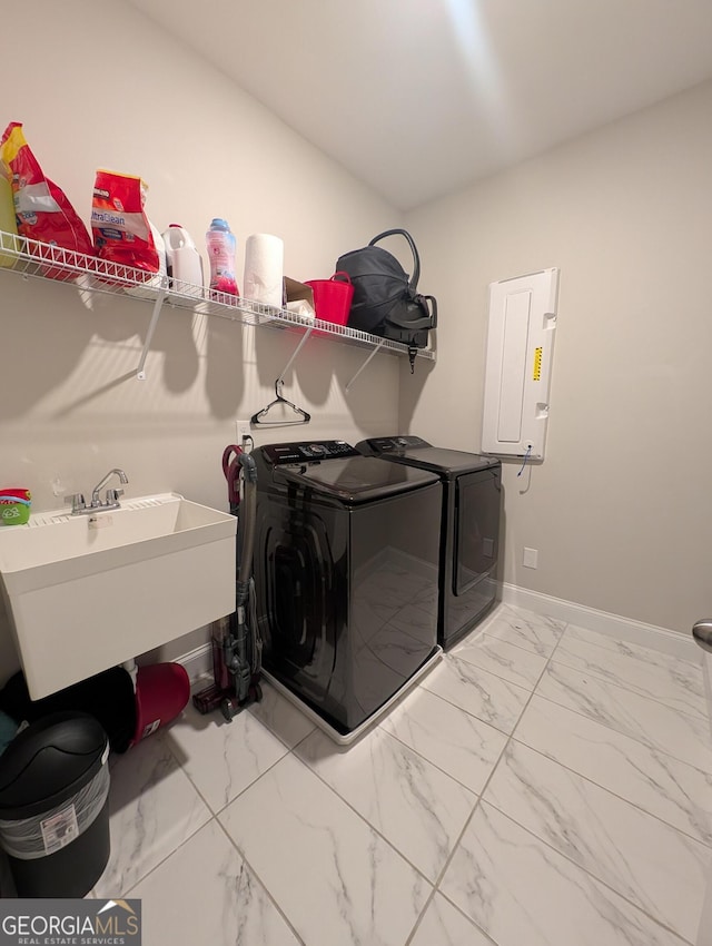 laundry room featuring independent washer and dryer, electric panel, and sink