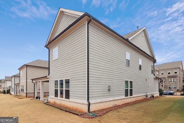 rear view of property with a lawn