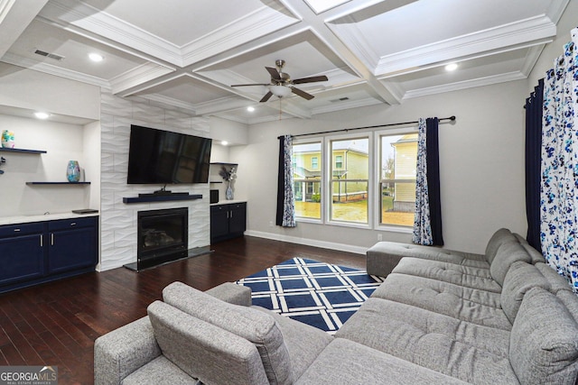 living room featuring a tile fireplace, beamed ceiling, dark wood-type flooring, and coffered ceiling