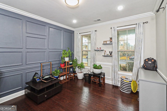 interior space featuring dark hardwood / wood-style floors, crown molding, and a wealth of natural light