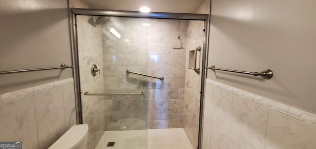 bathroom featuring an enclosed shower, toilet, and tile walls