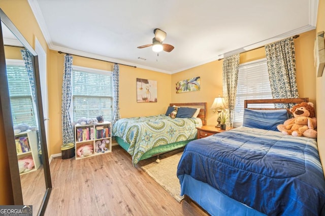 bedroom featuring wood-type flooring, ceiling fan, and crown molding