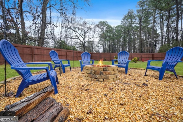 view of playground with a yard and an outdoor fire pit