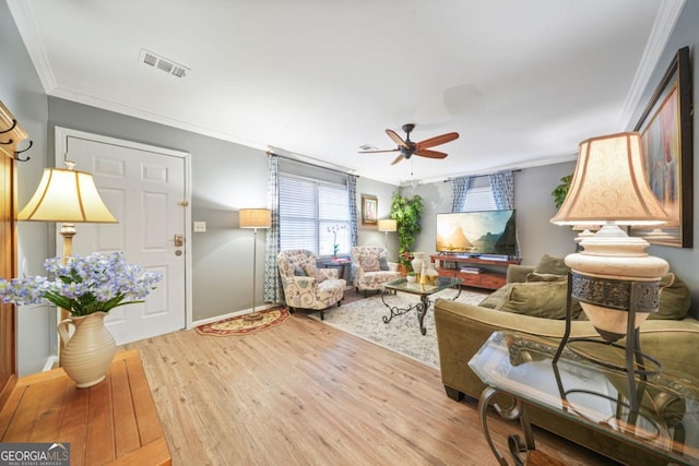 living room featuring ceiling fan, light hardwood / wood-style floors, and ornamental molding