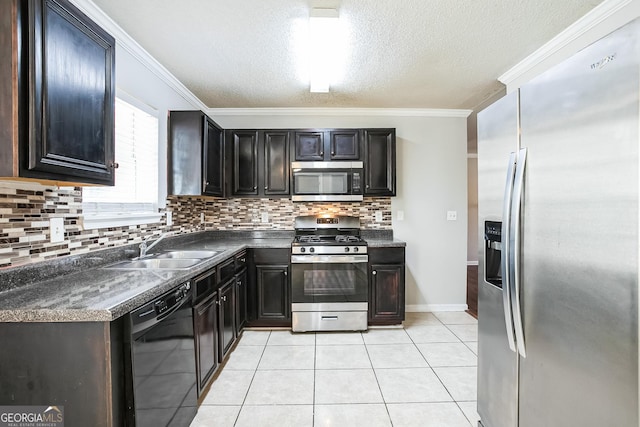 kitchen with a textured ceiling, ornamental molding, sink, and appliances with stainless steel finishes