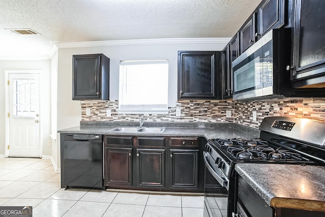 kitchen with appliances with stainless steel finishes, a textured ceiling, backsplash, and sink