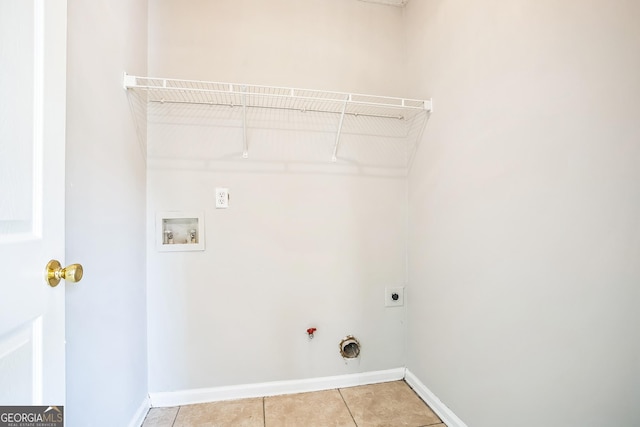 clothes washing area with electric dryer hookup, hookup for a gas dryer, hookup for a washing machine, and light tile patterned flooring