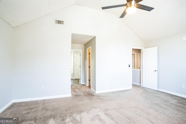 spare room featuring ceiling fan, high vaulted ceiling, and light colored carpet