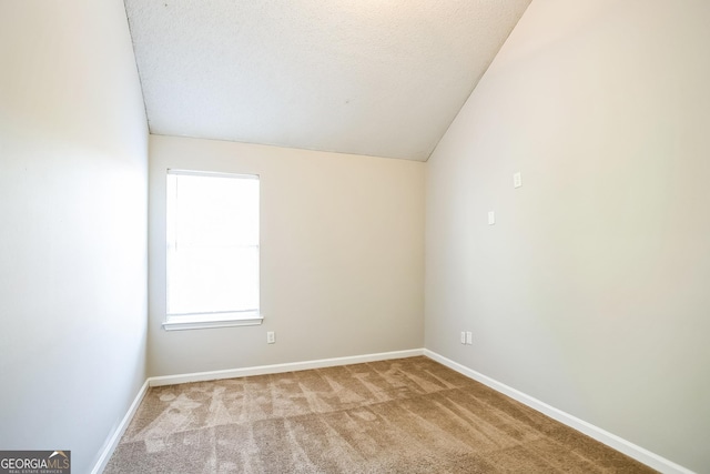 carpeted empty room with a textured ceiling