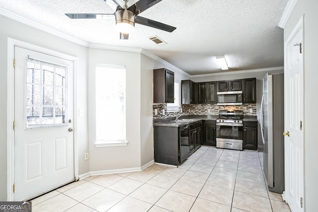 kitchen featuring decorative backsplash, ceiling fan, light tile patterned floors, appliances with stainless steel finishes, and dark brown cabinets