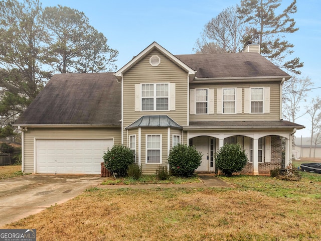 view of front of property with a front lawn and a garage