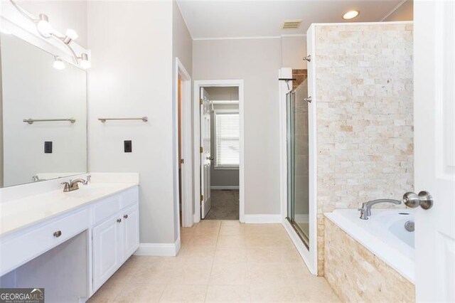 bathroom with shower with separate bathtub, vanity, and tile patterned floors