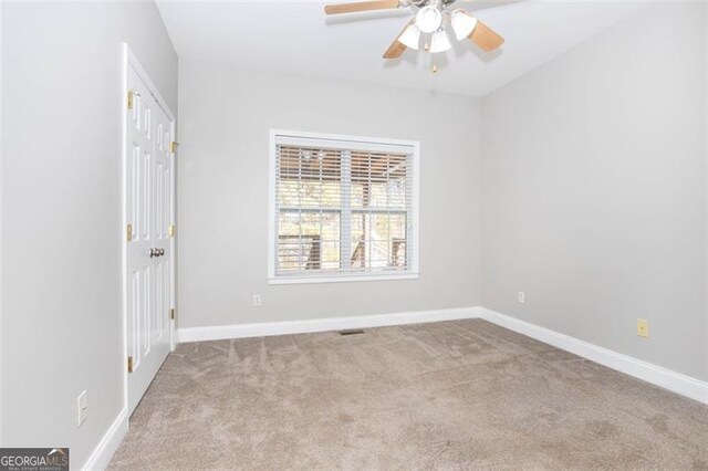 carpeted empty room with ceiling fan