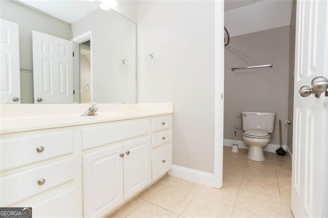 bathroom featuring tile patterned floors, vanity, and toilet