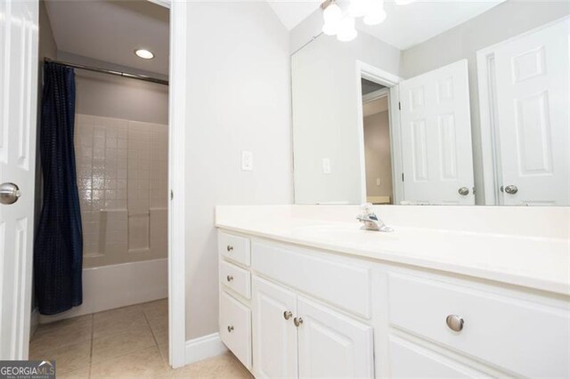 bathroom with tile patterned flooring, vanity, and shower / bath combo with shower curtain