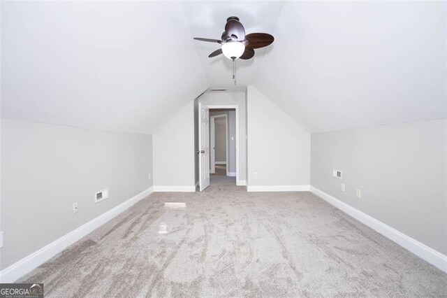 bonus room featuring ceiling fan, light carpet, and lofted ceiling