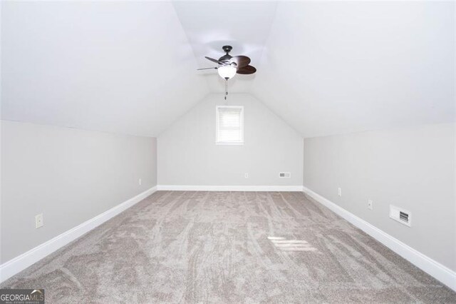 bonus room with ceiling fan, lofted ceiling, and light carpet