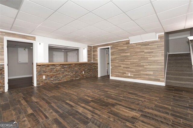 basement with dark hardwood / wood-style floors