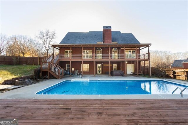 view of pool with a wooden deck