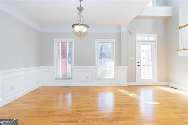 foyer featuring light hardwood / wood-style flooring and ornamental molding