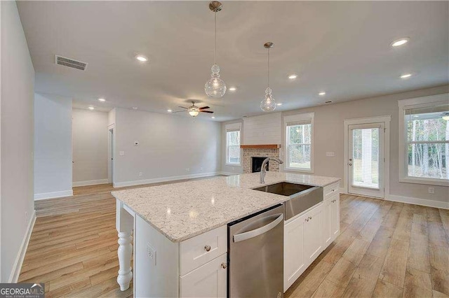 kitchen featuring dishwasher, white cabinets, light hardwood / wood-style floors, and sink