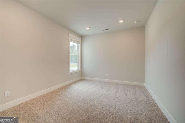 corridor with light colored carpet and a wealth of natural light