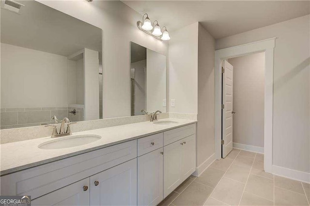 bathroom featuring tile patterned flooring and vanity