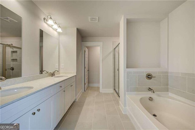 bathroom featuring tile patterned floors and separate shower and tub