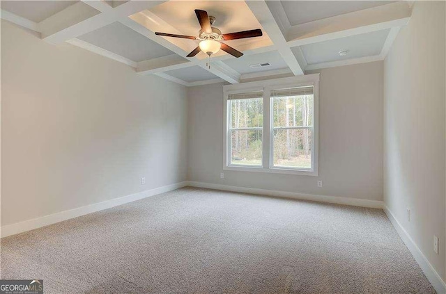 carpeted spare room featuring beam ceiling, ceiling fan, and coffered ceiling